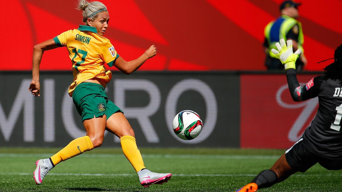 Australia striker Kyah Simon chips a shot past Nigeria goalkeeper Precious Dede for a goal in the first half of their Women's World Cup gorup game on Friday.