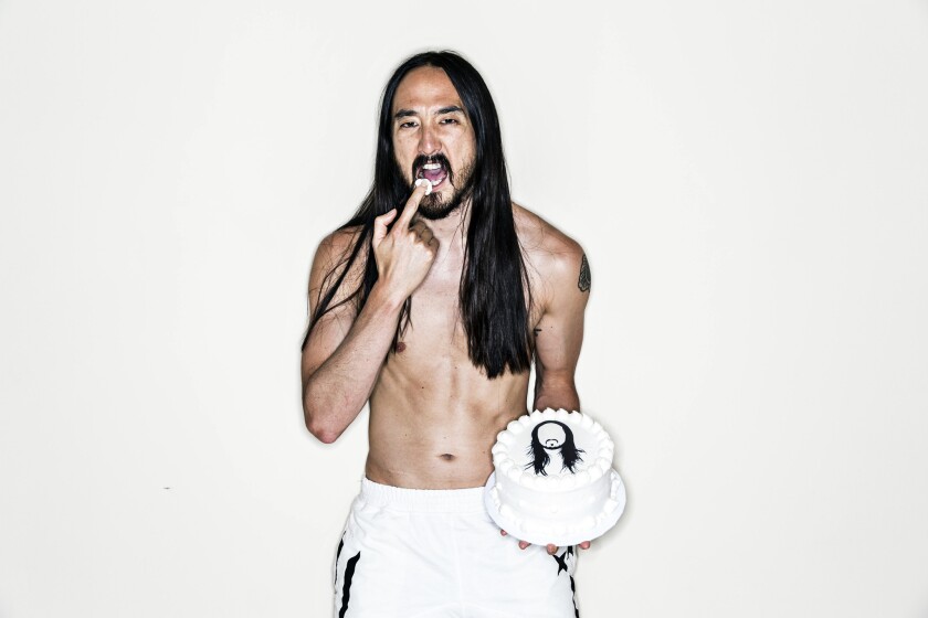 Grammy-nominated music producer and DJ Steve Aoki is photographed at his Las Vegas area home, holding a custom-made cake topped with an image of his silhouette. Aoki is known for throwing sheet cakes at people during his shows.
