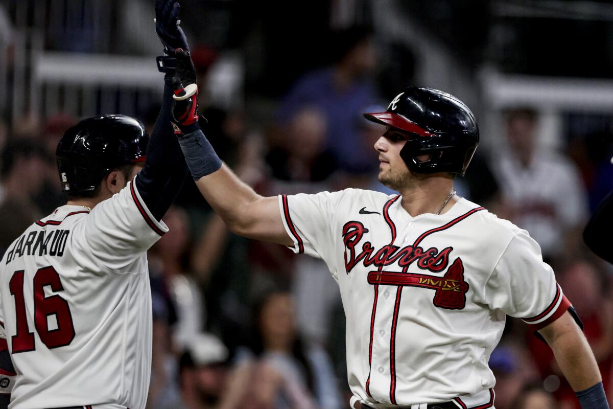 The Braves' Austin Riley, right, is congratulated by Travis d'Arnaud after a two-run, fourth-inning home run July 23, 2022.