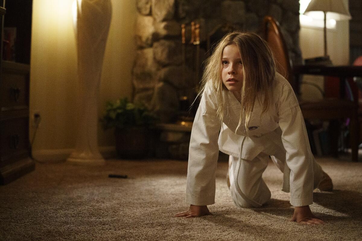 A feral young girl in a karate gi crouches to fight in Season 2 of HBO's "Barry."