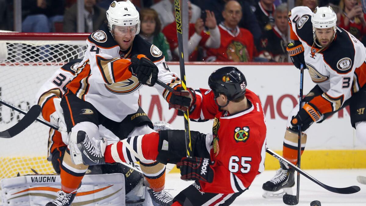 Ducks defenseman Cam Fowler shoves Chicago Blackhawks center Andrew Shaw to the ice during the first period of the Ducks' 1-0 win Tuesday.