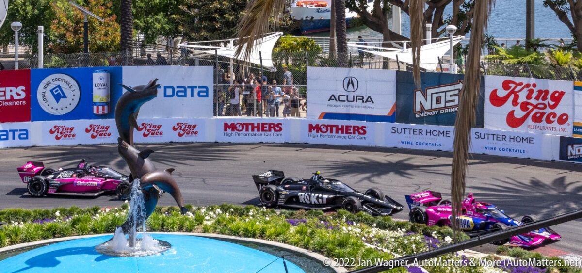 IndyCars racing around the iconic dolphin fountain