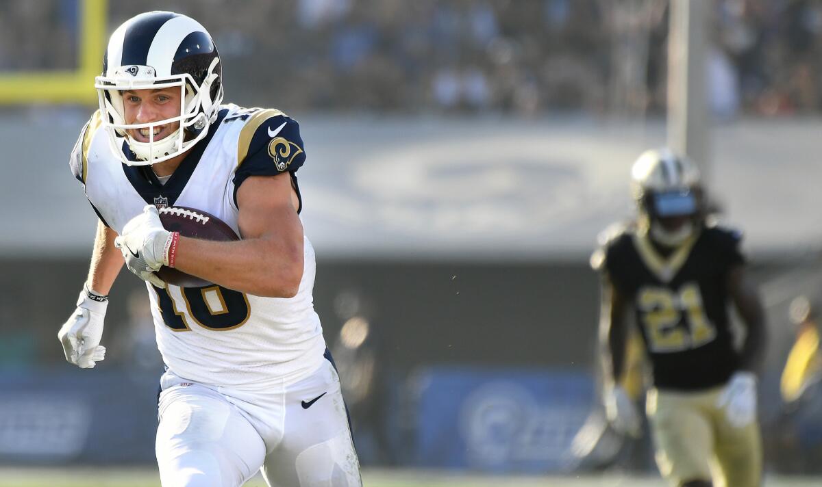 Rams receiver Cooper Kupp picks up big yards after a reception against the Saints in the second quarter Sunday.