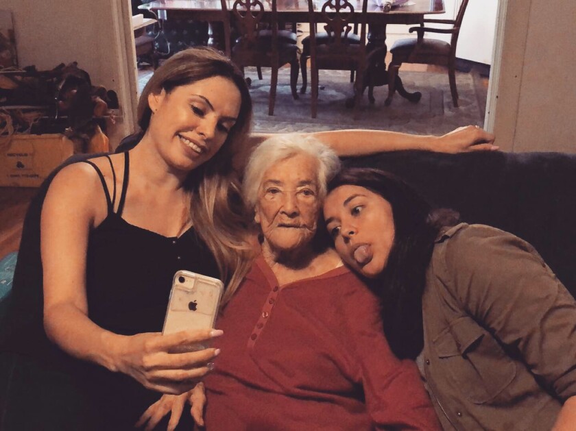Sisters Crystal Vargas, left, and Brittny Mejia with their grandmother María Díaz at her home in Highland Park.