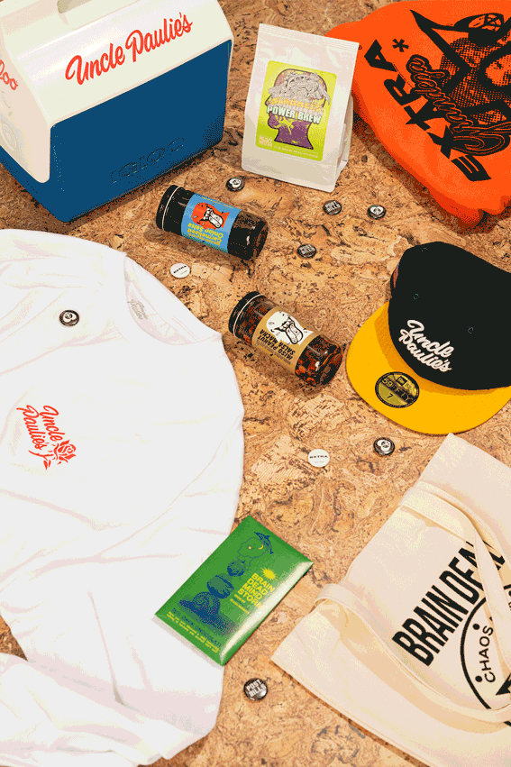 A gif of food-inspired merchandise including an Igloo cooler and cap that say "Uncle Paulie's" and a Brain Dead totebag