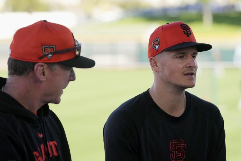 New San Francisco Giants infielder Matt Chapman, right, answers a question at a baseball news conference announcing his signing as Giants manager Bob Melvin, left, listens Monday, March 4, 2024, in Scottsdale, Ariz. (AP Photo/Ross D. Franklin)