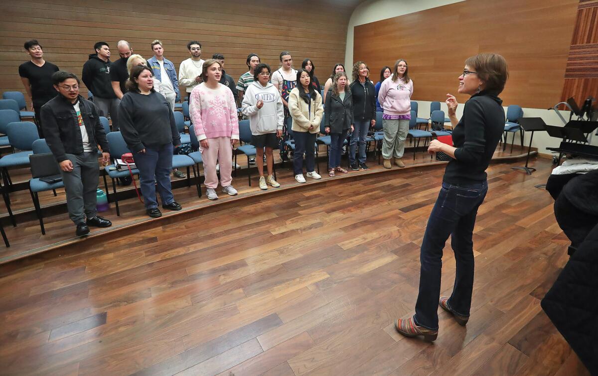 Orange Coast College conductor Eliza Rubenstein leads some of the chamber singers during a session Friday. 