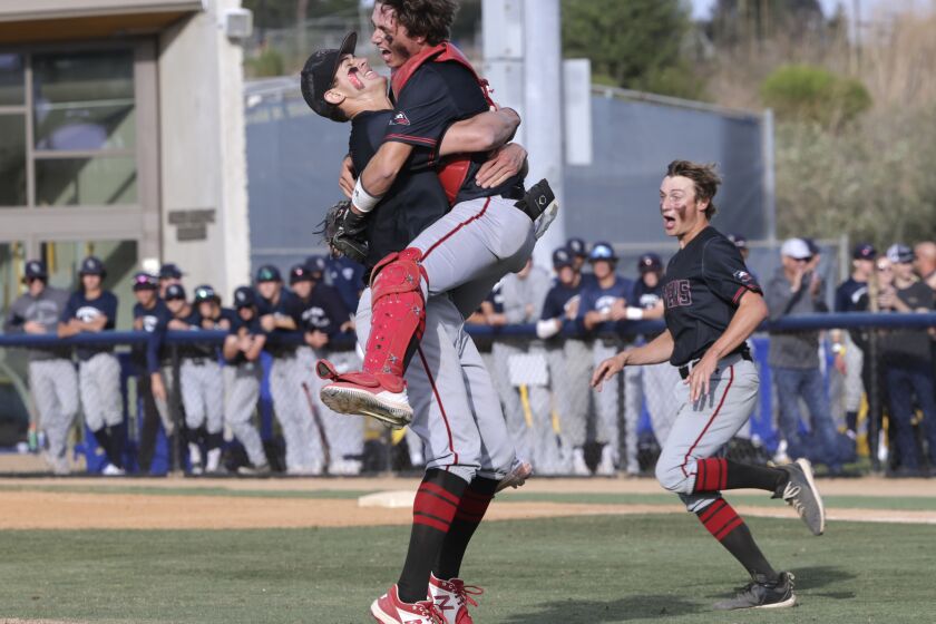 SAN DIEGO, CA - MAY 27, 2022: Canyon Crest Academy's catcher Ethan Swidler jumps into the arms of pitcher Sam Garewal as they and teammates celebrate after defeating Montgomery 2-0 to win the CIF Division II baseball championship game at UCSD in San Diego on Friday, May 27, 2022. (Hayne Palmour IV / For The San Diego Union-Tribune)