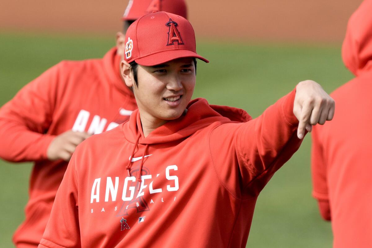 Angels star Shohei Ohtani gestures during a spring training baseball workout.