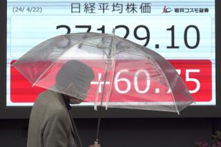 A person walks in front of an electronic stock board showing Japan's Nikkei 225 index at a securities firm Monday, April 22, 2024, in Tokyo. (AP Photo/Eugene Hoshiko)