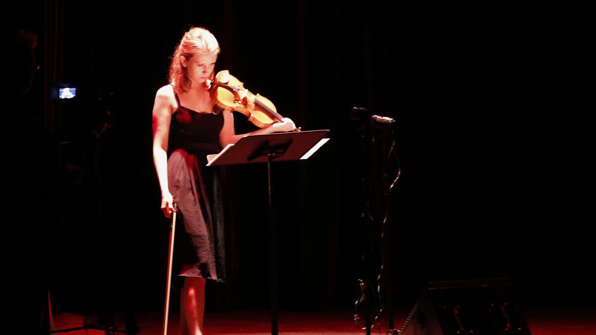 Parisian violinist Aliisa Neige Barriere performed a piece accompanied by one of Barriere's Jean-Baptiste visual compositions.