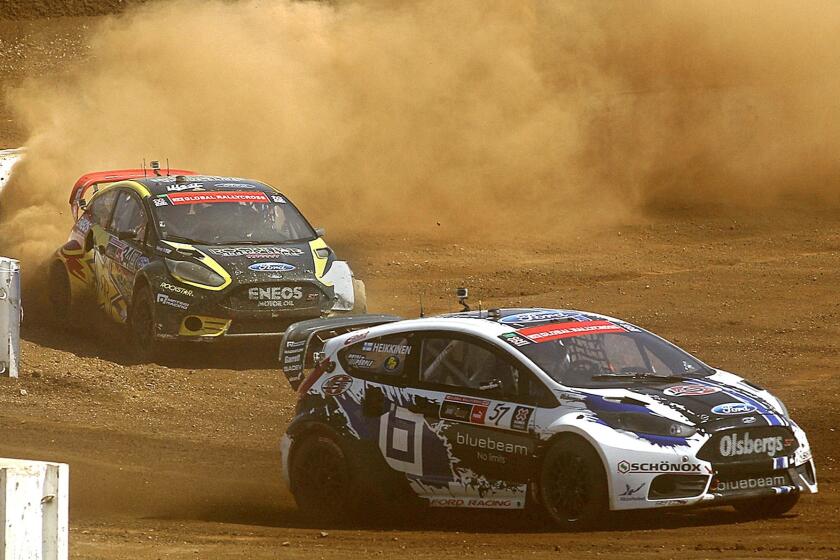 Drivers Toomas Heikkinen, right, and Tanner Foust compete in the X Games RallyCross SuperCar Final at Irwindale Event Center on Sunday.