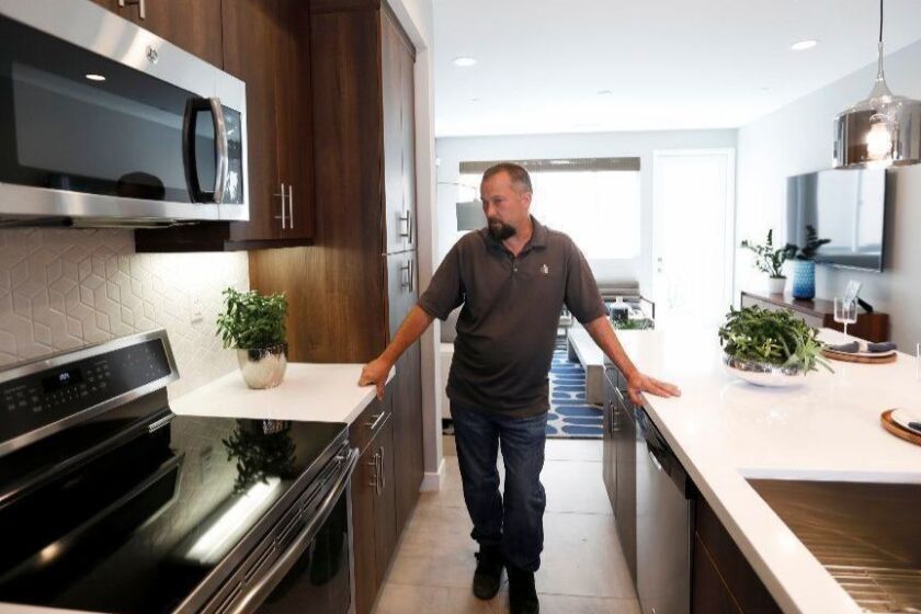 Bellflower, CA MARCH 25, 2019: Construction Manager Chris Smith in Bellflower, CA MARCH 25, 2019. He is discussing the induction cooktop in the kitchen in Bellflower, CA. The project is being built by City Ventures, with all-electric homes. Some of the homes are still under construction; others are finished. (Francine Orr/ Los Angeles Times)