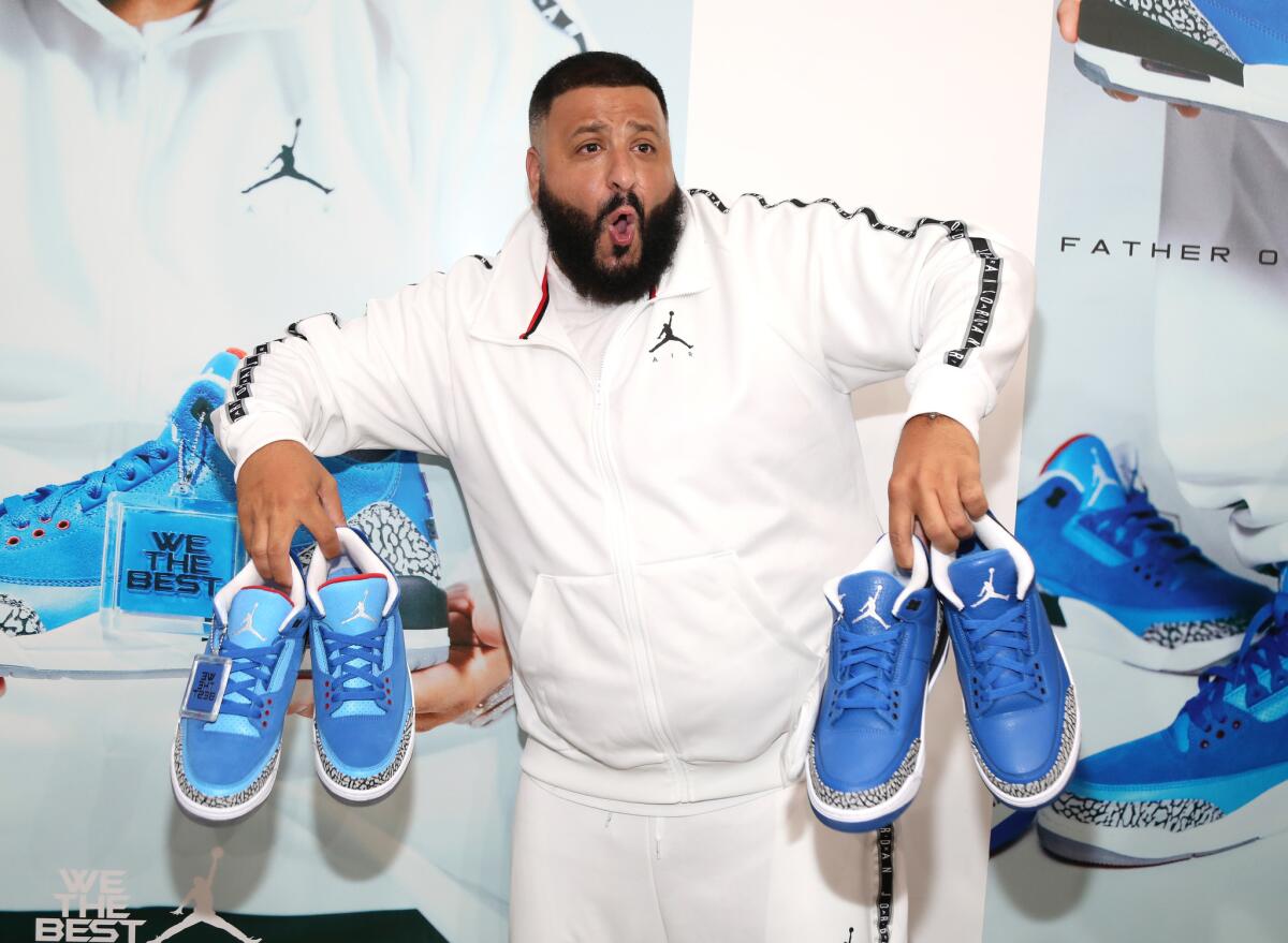 DJ Khaled unveils the efforts of his Jordan Brand footwear collaboration — the Father of Asahd III, left, and Another One III sneakers — during a recent appearance in Los Angeles.