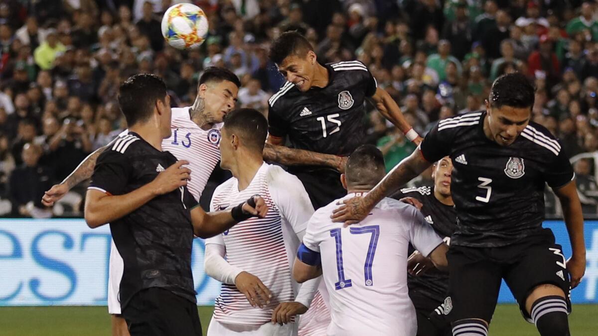 Mexico's Hector Moreno, above right, heads the ball in for a goal during the second half of an international friendly soccer match against Chile on Friday in San Diego.