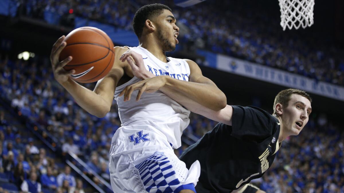 Kentucky's Karl-Anthony Towns, left, drives to the basket over Vanderbilt's Luke Kornet during the Wildcats' 65-57 win on Jan. 20.