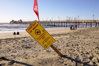 Imperial Beach, CA - February 15: A water contamination sign warns beach goers about high bacteria in the water in Imperial Beach on February 15, 2023. A pipeline break south of Tijuana last week has triggered an ongoing sewage spill along the border, as a pump station spews up to 50 million gallons a day of raw effluent, according to federal officials. Beaches are closed as far north as the Silver Strand. (Nelvin C. Cepeda / The San Diego Union-Tribune)