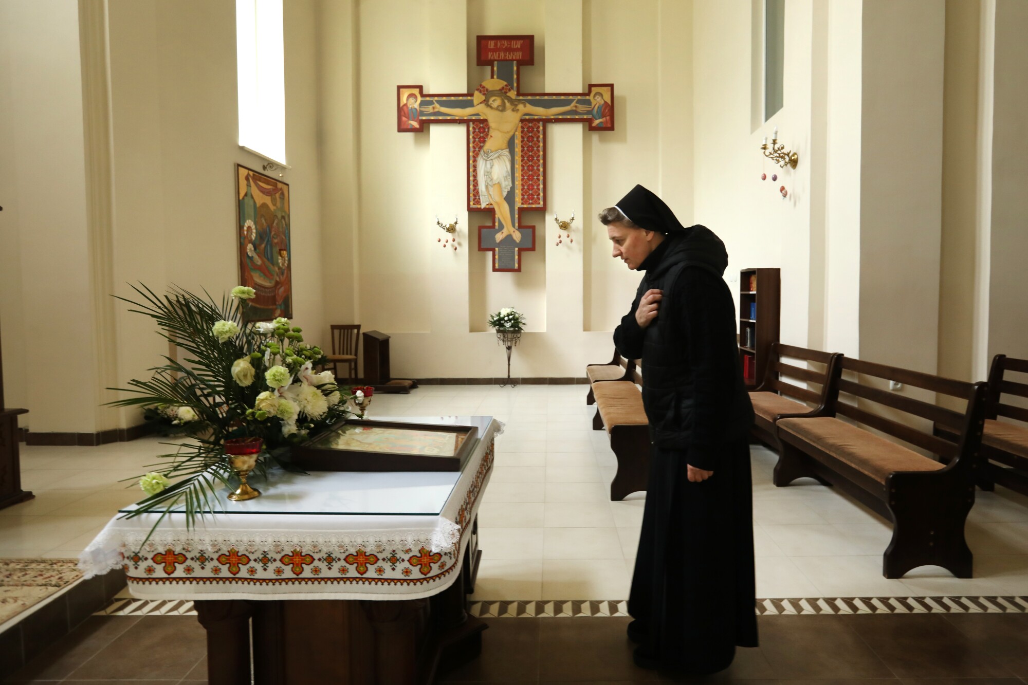 Sister Bernadette says a brief prayer in the chapel at the Sisters of the Holy Family monastery.