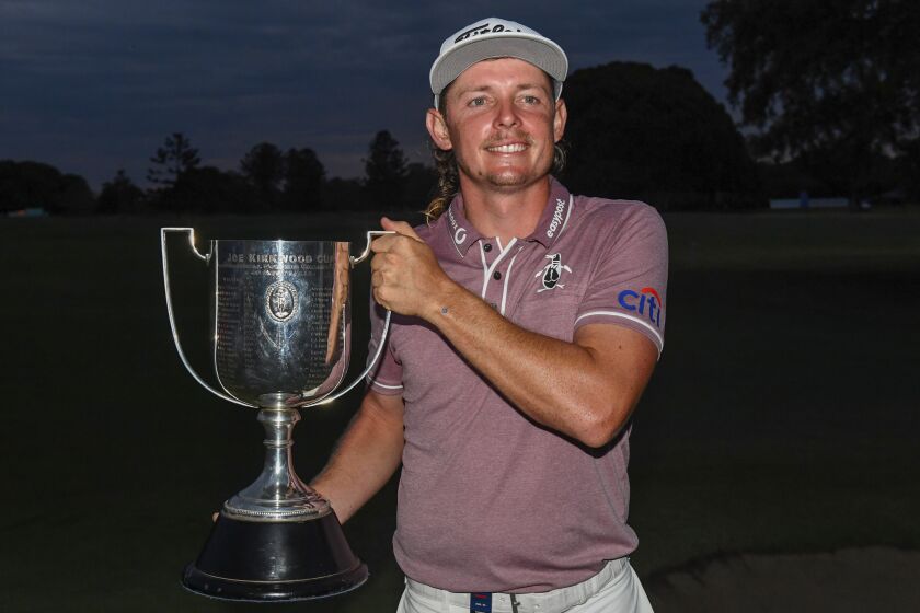 Australia's Cameron Smith poses with the trophy after winning the Australian PGA Championship at the Royal Queensland Golf Club in Brisbane, Sunday, Nov. 27, 2022. The world No.3 Smith shot a three-under 68 to finish 14-under par, three strokes clear. (Jono Searle/AAP Image via AP)