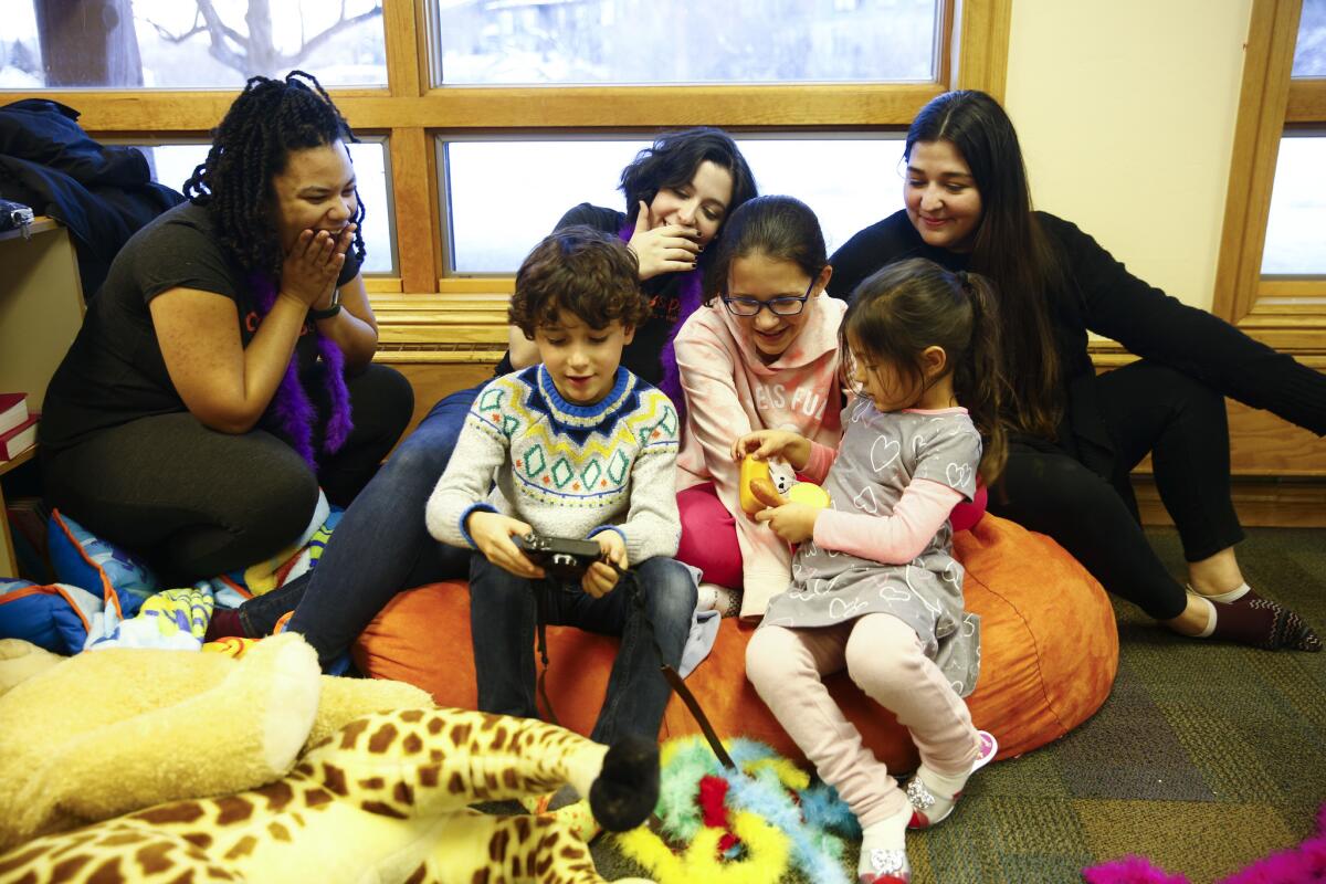 The on-site childcare group Collab & Play teamed with Moms in Film at January's Sundance Film Festival. From left, teachers Arielle Jennings, Jessica Ghitis and Mia Mollicone, watch clips from a movie they were making with Noa Strange, Zoe Strange, and Axia Rivera.