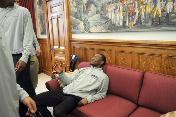 UConn guard Kemba Walker chills on a couch in Gov. Dannel Malloy's office during a visit to the State Capitol on Husky Day. The men's and women's basketball teams and several members of the football team along with coaches and assistants visited the governor's office, the Hall of the House and the Senate Chamber where they were all honored for their successful seasons.