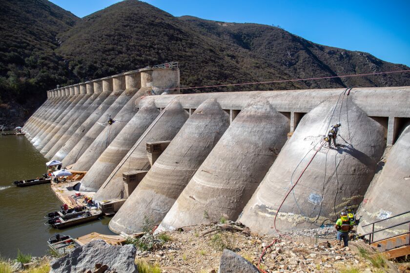 Escondido, CA - August 18: The lower water levels people might be seeing at Lake Hodges are not drought-related but instead are due to the ongoing work repairing the 100-year-old Lake Hodges Dam. The emergency work on the dam began in May and is expected to be completed by October. Lake Hodges Dam on Thursday, Aug. 18, 2022 in Escondido, CA. (Don Boomer / For The San Diego Union-Tribune)