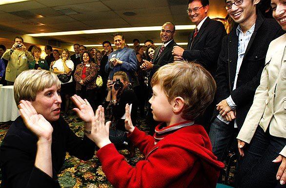 Los Angeles City Councilwoman Wendy Greuel trades high fives with her son, Thomas Schramm, 5, during an election night party at the Sportsmens Lodge in Studio City. She appeared to have enough votes to avoid a runoff in May in her bid for city controller.
