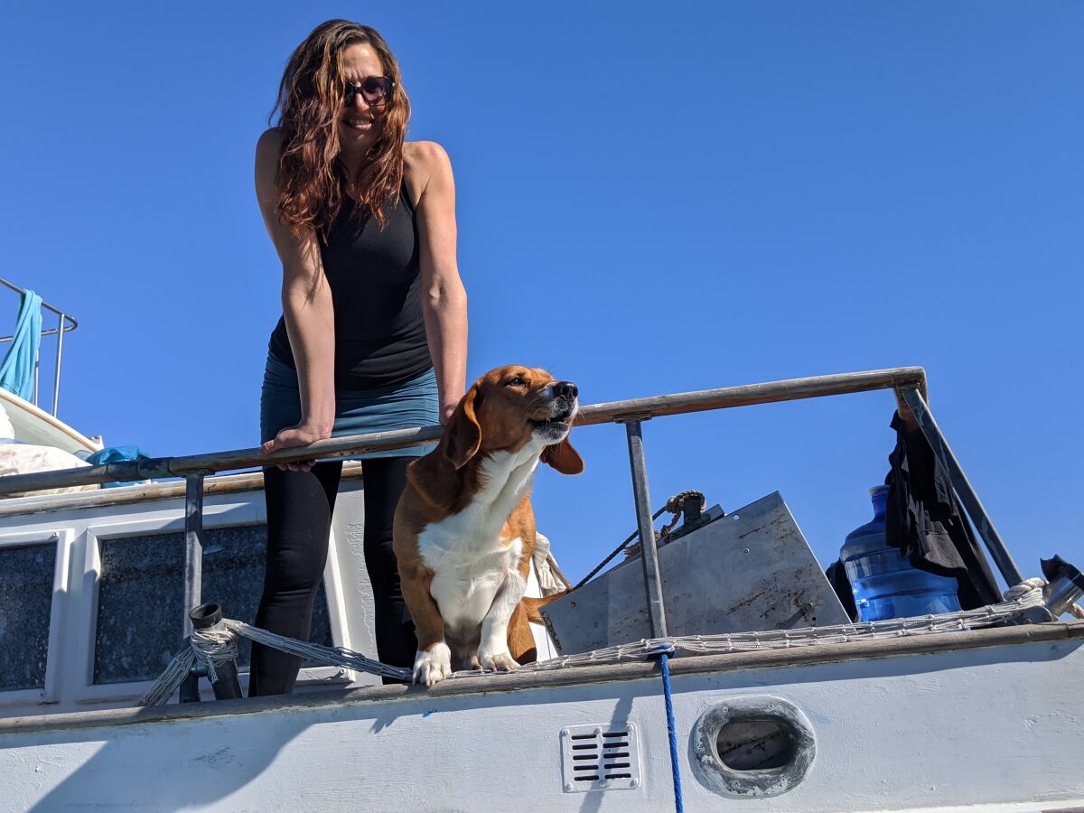 Kristina Weber and her dog, Poseidon, on her boat in Richardson Bay in 2019. 