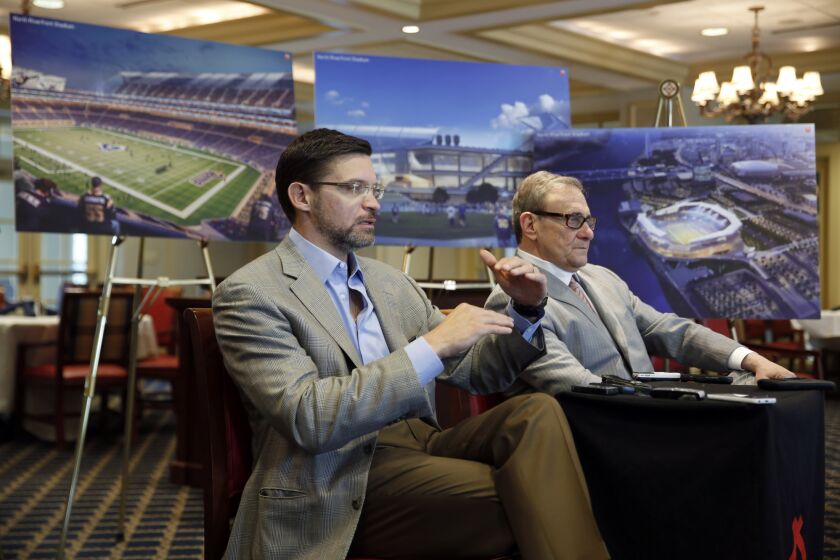 With artist's renderings as a backdrop, Dave Peacock, left, and Bob Blitz speak to reporters on April 24 about an effort to build a new NFL stadium in St. Louis.