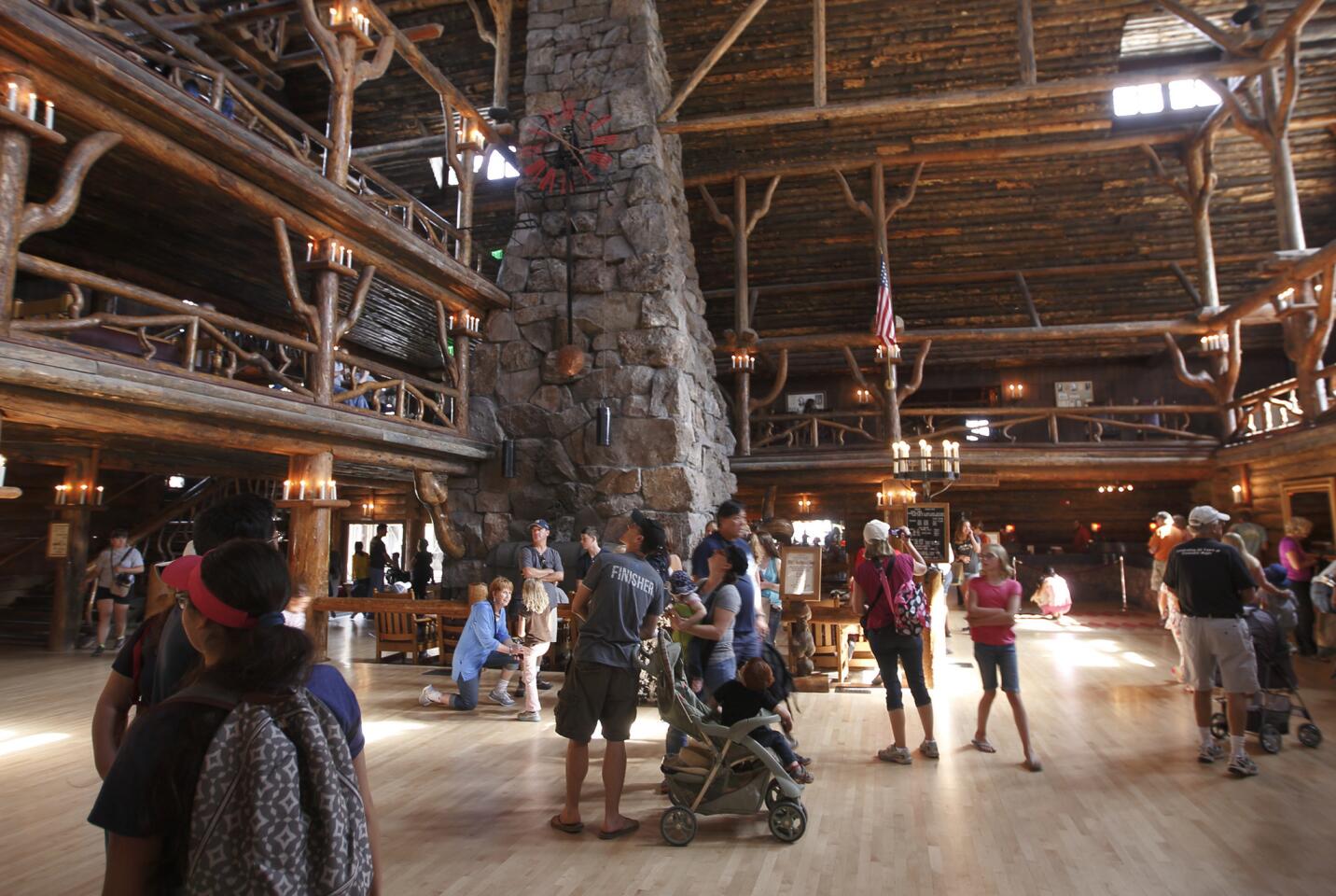 A towering fireplace and a handmade clock are a few of the features found in the lobby of The Old Faithful Inn, built from local logs and stone in 1904.