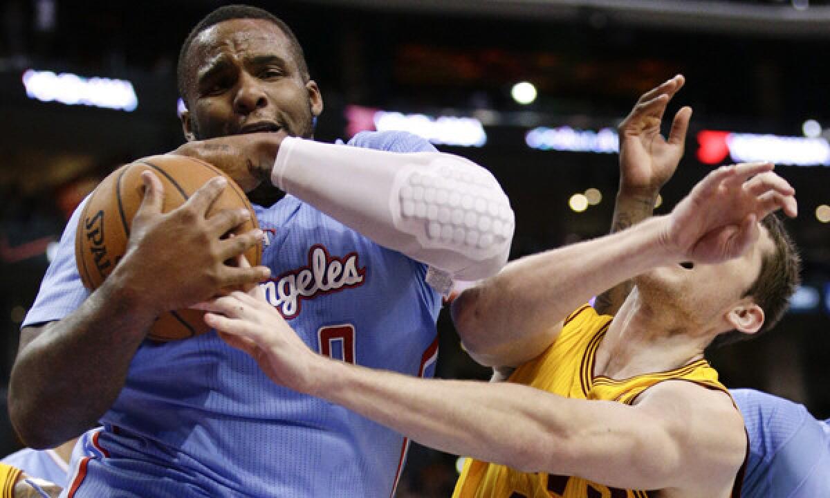 Clippers power forward Glen Davis, left, battles Cleveland Cavaliers center Tyler Zeller for a rebound during a March 16 game. Davis says he's still in the process of getting to know his Clippers teammates.