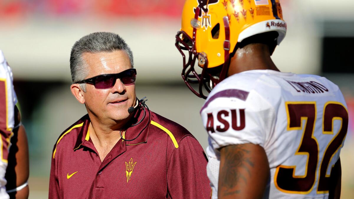 Arizona State Coach Todd Graham, left, talks to linebacker Antonio Longino during a game against Arizona on Nov. 28, 2014.