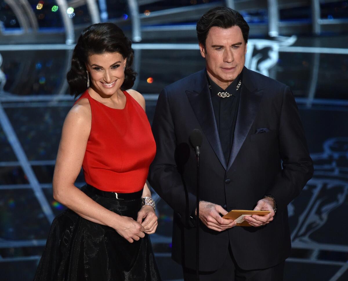 Idina Menzel and John Travolta present the Oscar for original song.