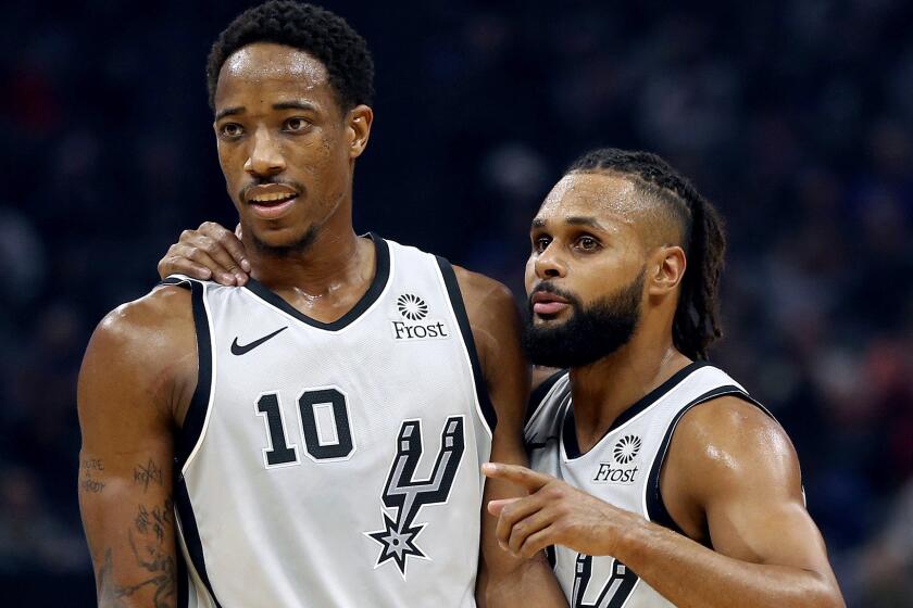 San Antonio Spurs guard Patty Mills, right, talks with teammate DeMar DeRozan during the second quarter of an NBA basketball game against the Sacramento Kings Monday, Nov. 12, 2018, in Sacramento, Calif.(AP Photo/Rich Pedroncelli)