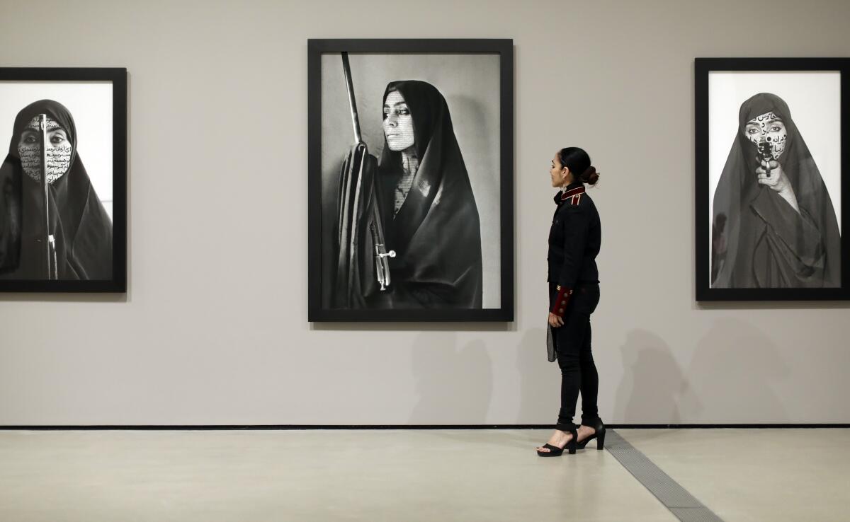Shirin Neshat stands before her "Women of Allah" series at the Broad