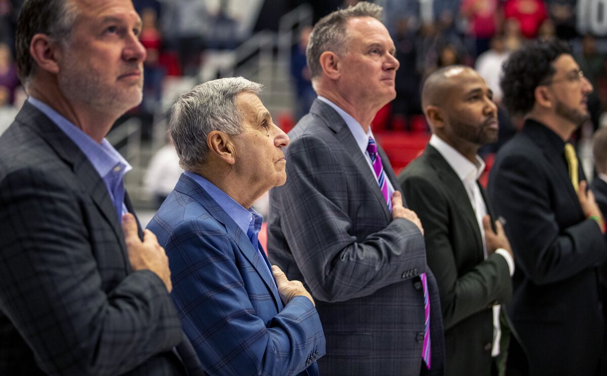 Jim Harrick, second from left, stands with the Cal State Northridge coaching staff during national anthem Jan. 8 prior to a game against Long Beach State.