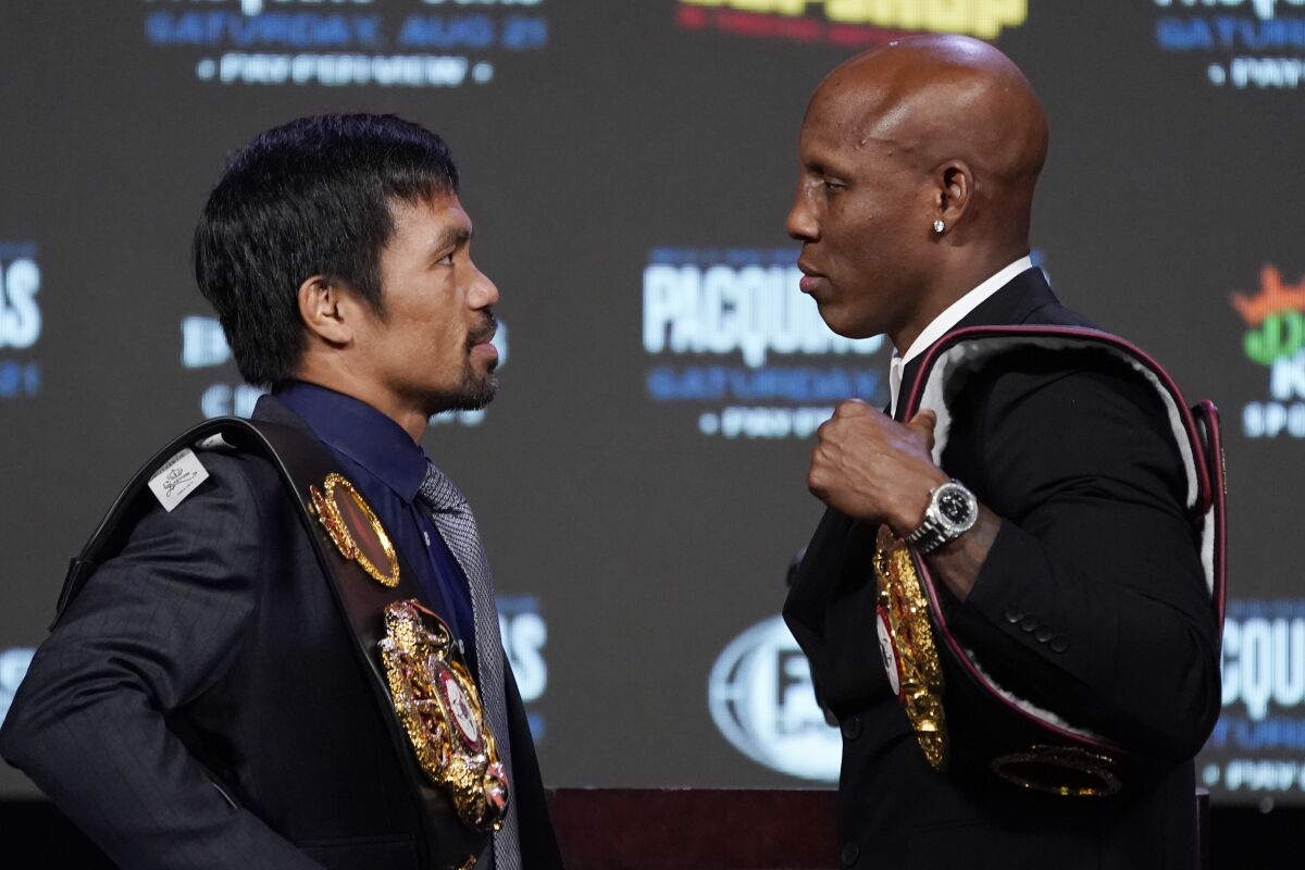 Manny Pacquiao, left, and Yordenis Ugas are scheduled to fight in a welterweight championship bout on Saturday.