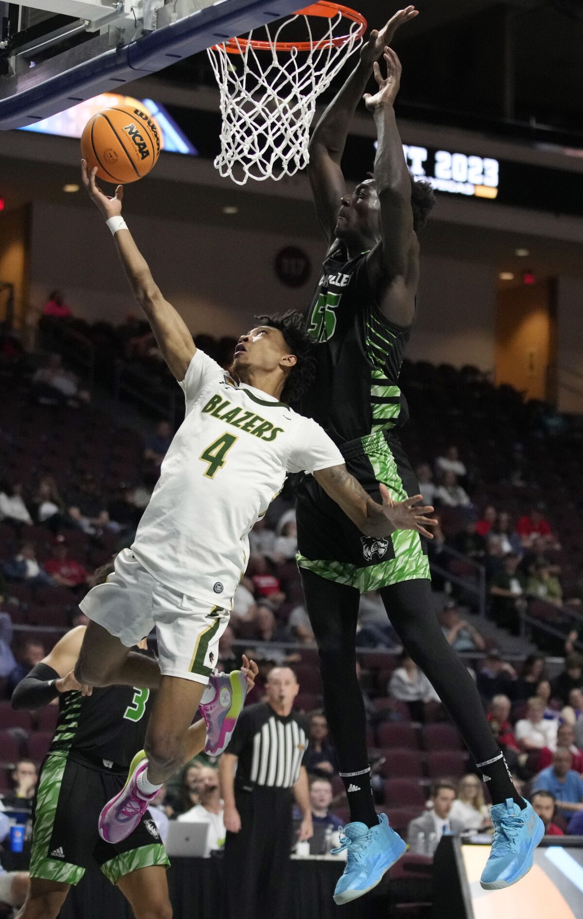 UAB's Eric Gaines (4) shoots around Utah Valley's Aziz Bandaogo (55) during the first half of an NCAA college basketball game in the semifinals of the NIT, Tuesday, March 28, 2023, in Las Vegas. (AP Photo/John Locher)