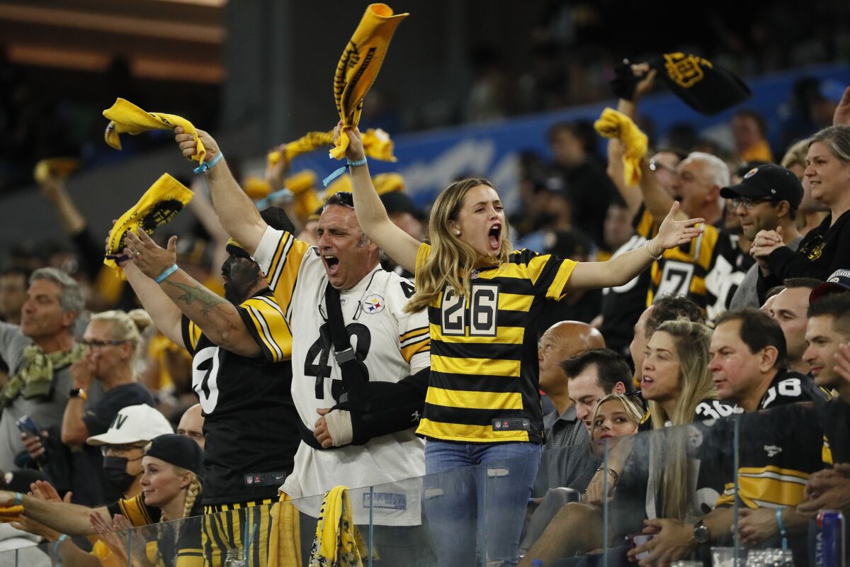 Steelers fans scream as Pittsburgh rallies to tie the score at 34 against the Chargers.