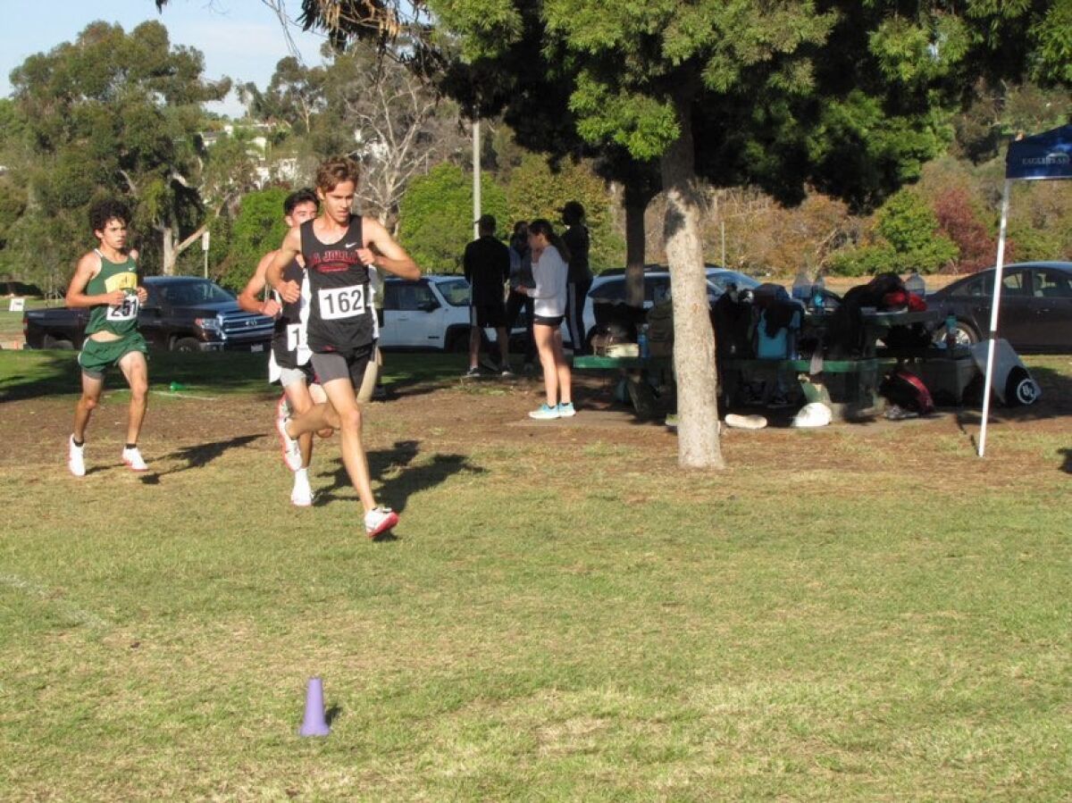 La Jolla High School senior Ronald Way (162) runs during a cross country race.