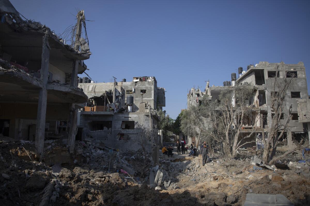 Palestinians inspect their destroyed homes in the Gaza Strip.