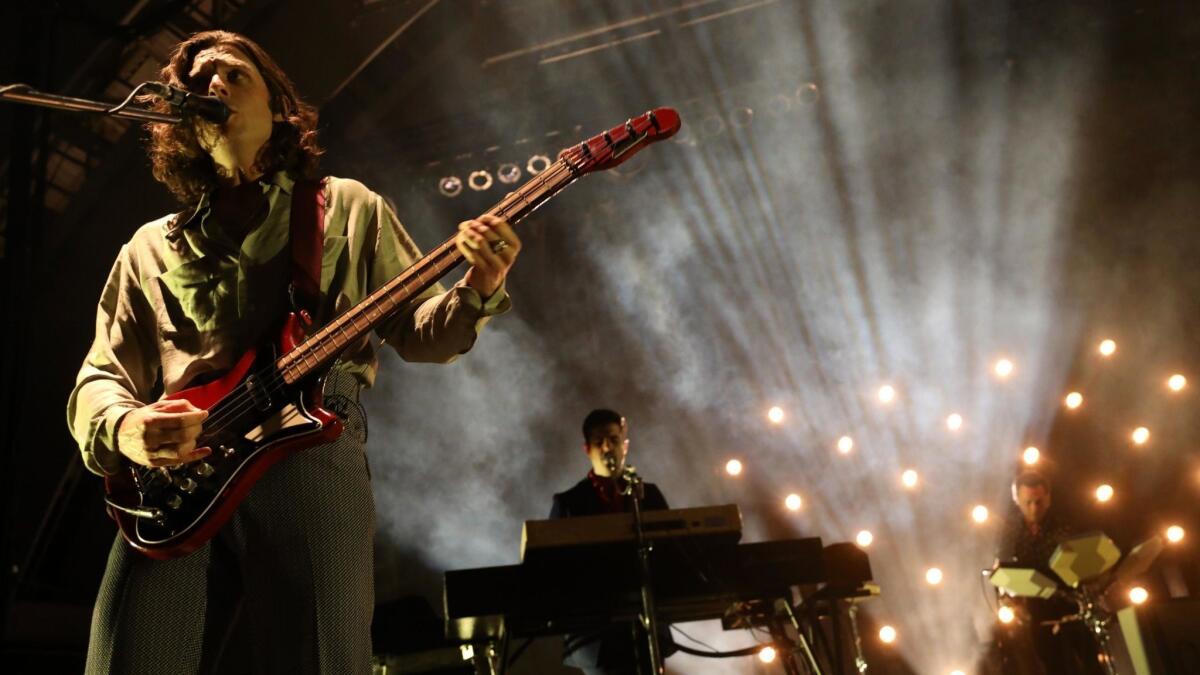 Bassist Nick O'Malley, left, plays with the U.K. indie rock group Arctic Monkeys at the Hollywood Bowl on Oct. 16.