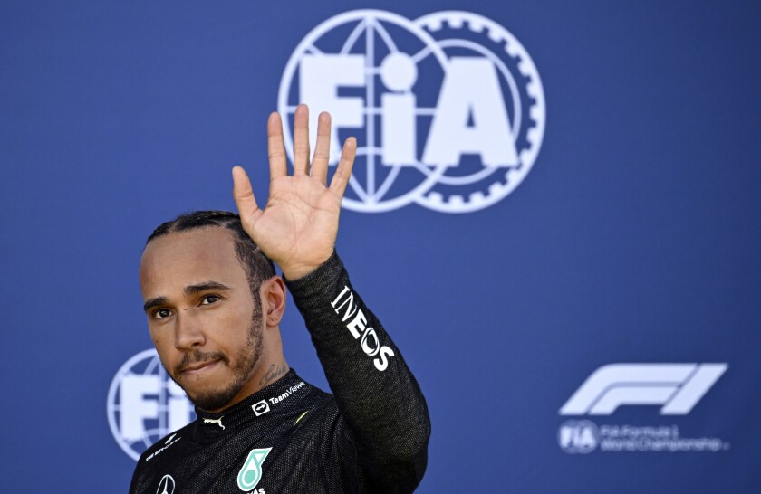 Mercedes driver Lewis Hamilton of Britain waves and walks back to his pits after he crashed into the track wall during a qualifying session at the Red Bull Ring racetrack in Spielberg, Austria, Friday, July 8, 2022. The Austrian F1 Grand Prix will be held on Sunday July 10, 2022. (Christian Bruna/Pool via AP)