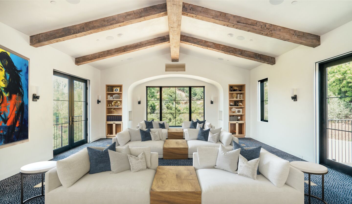 Set on nearly two acres, the stylish home expands to a loggia, stone terrace, spacious yard and swimming pool.