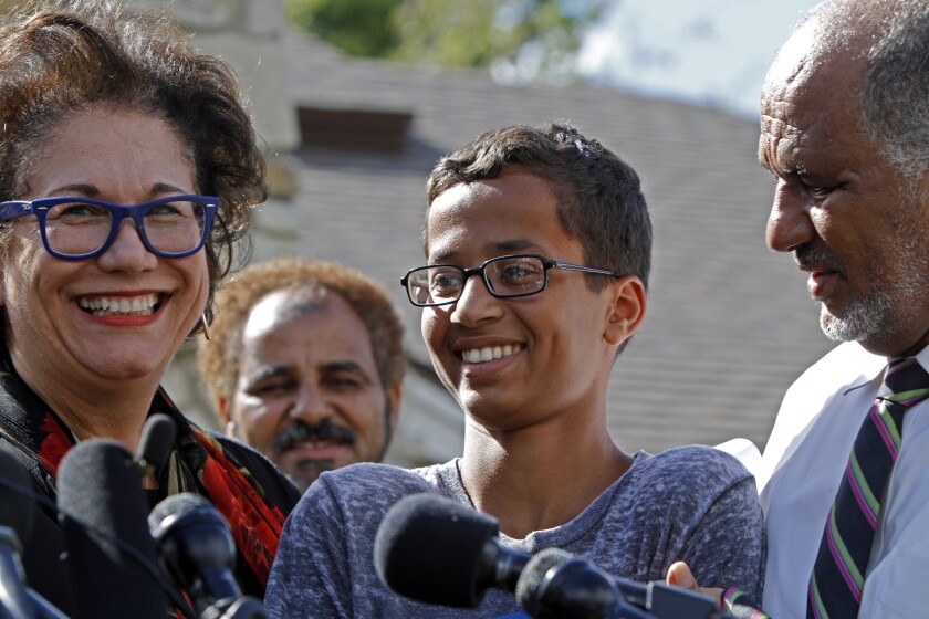 Attorney Linda Moreno, Ahmed Mohamed, and his father, Mohamed El Hassan, address the media during a news conference on Wednesday in Irving, Texas. Ahmed, 14, was detained after a high school teacher falsely concluded that a homemade clock he brought to class might be a bomb.