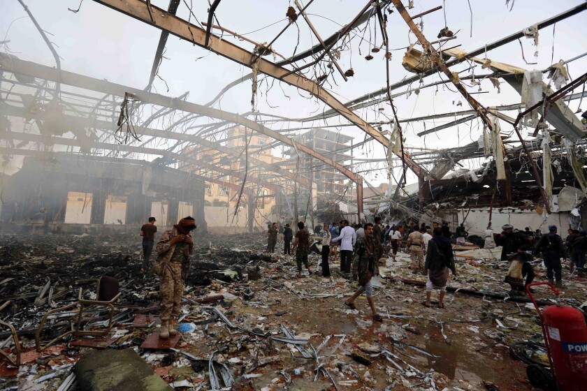 FILE - In this Oct. 8, 2016 file photo, people inspect the aftermath of a Saudi-led coalition airstrike in Sanaa, Yemen. Yemen’s war began in September 2014, when the Houthis seized the capital Sanaa. Saudi Arabia, along with the United Arab Emirates and other countries, entered the war alongside Yemen’s internationally recognized government in March 2015. The war has killed some 130,000 people and driven the Arab world’s poorest country to the brink of famine. (AP Photo/Osamah Abdulrhman, File)