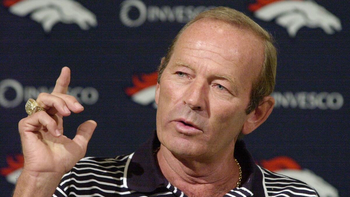Denver Broncos owner Pat Bowlen gestures during a news conference at the team's headquarters in 2002. Bowlen died on Thursday.