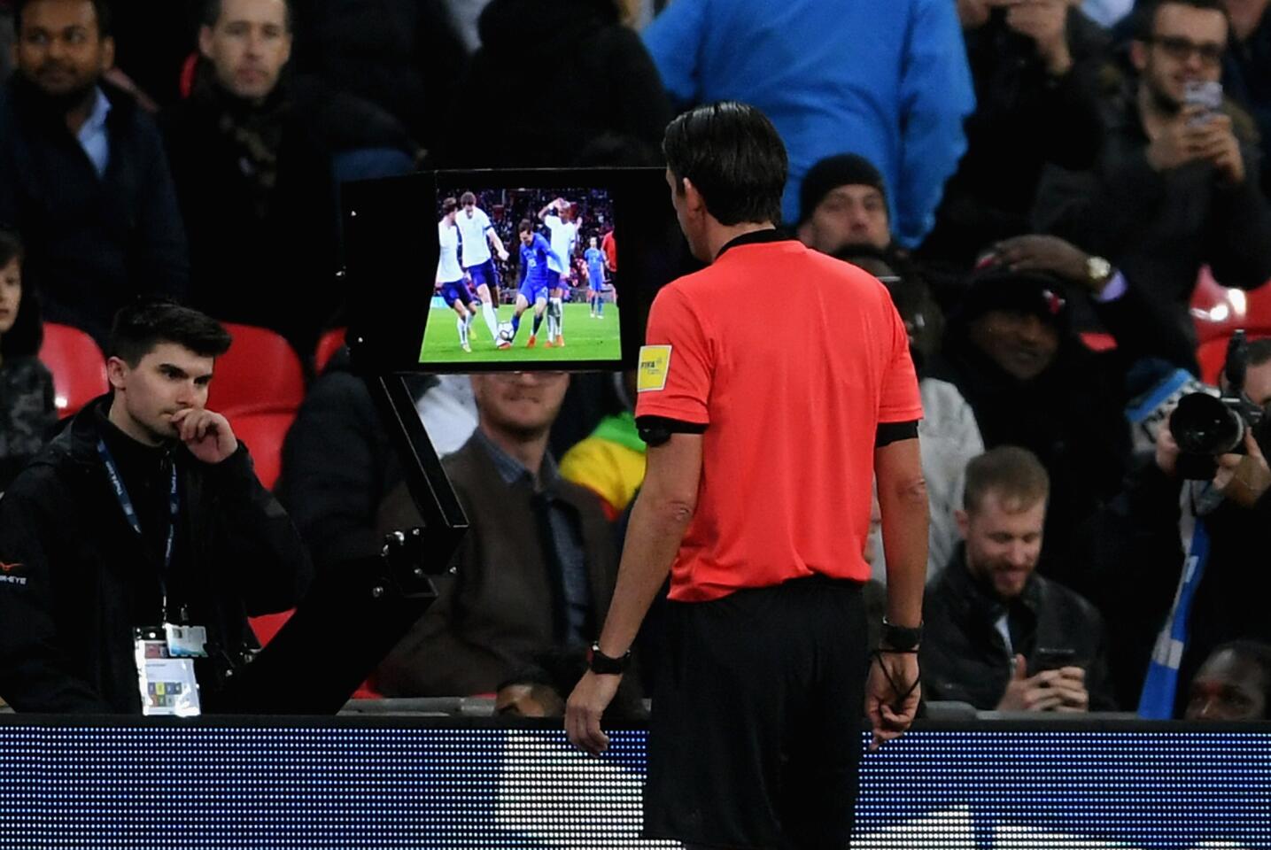 LONDON, ENGLAND - MARCH 27: Referee Deniz Aytekin checks the VAR during the International friendly between England and Italy at Wembley Stadium on March 27, 2018 in London, England.