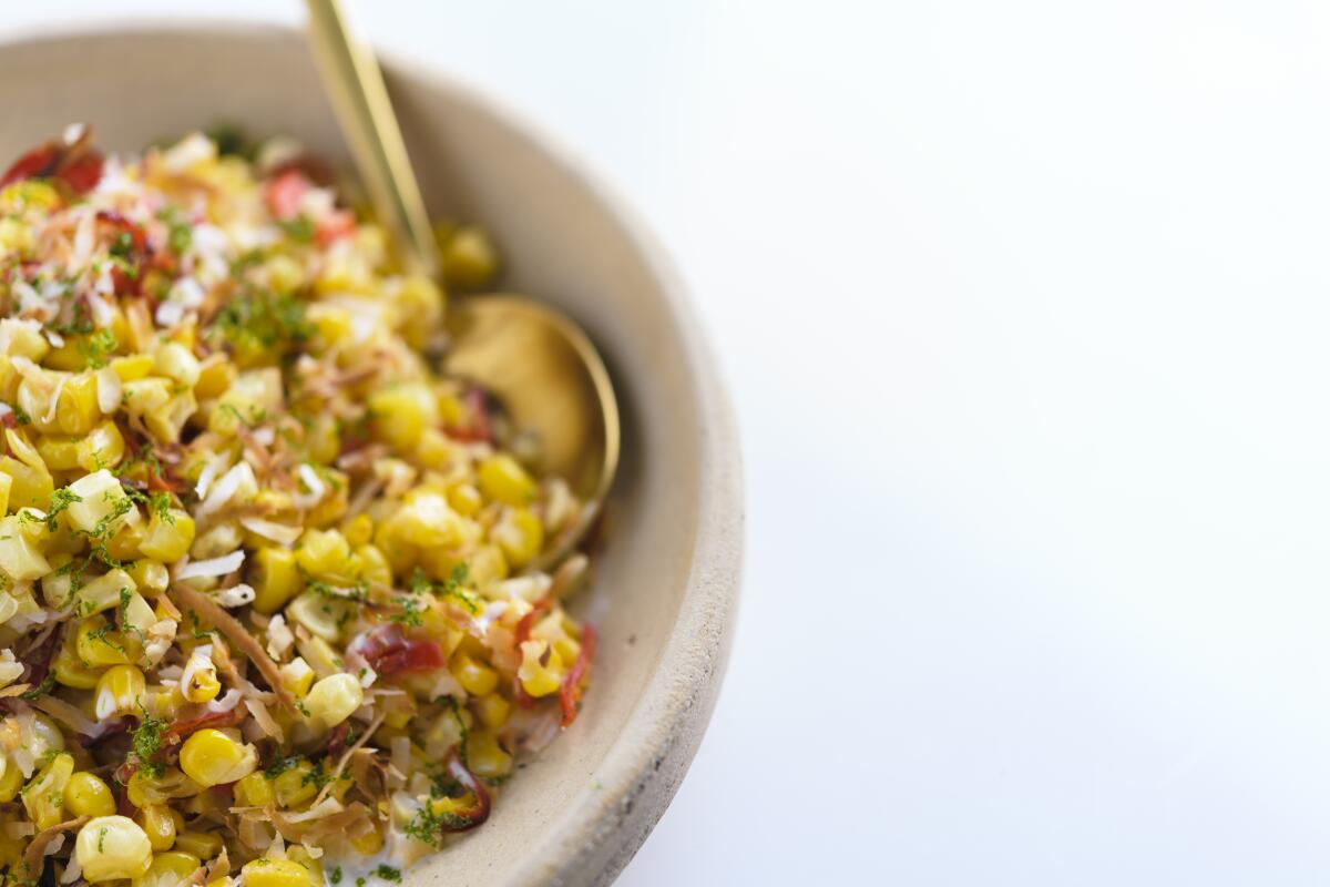 This image released by Milk Street shows a recipe for charred corn with coconut, chilies and lime. (Milk Street via AP)