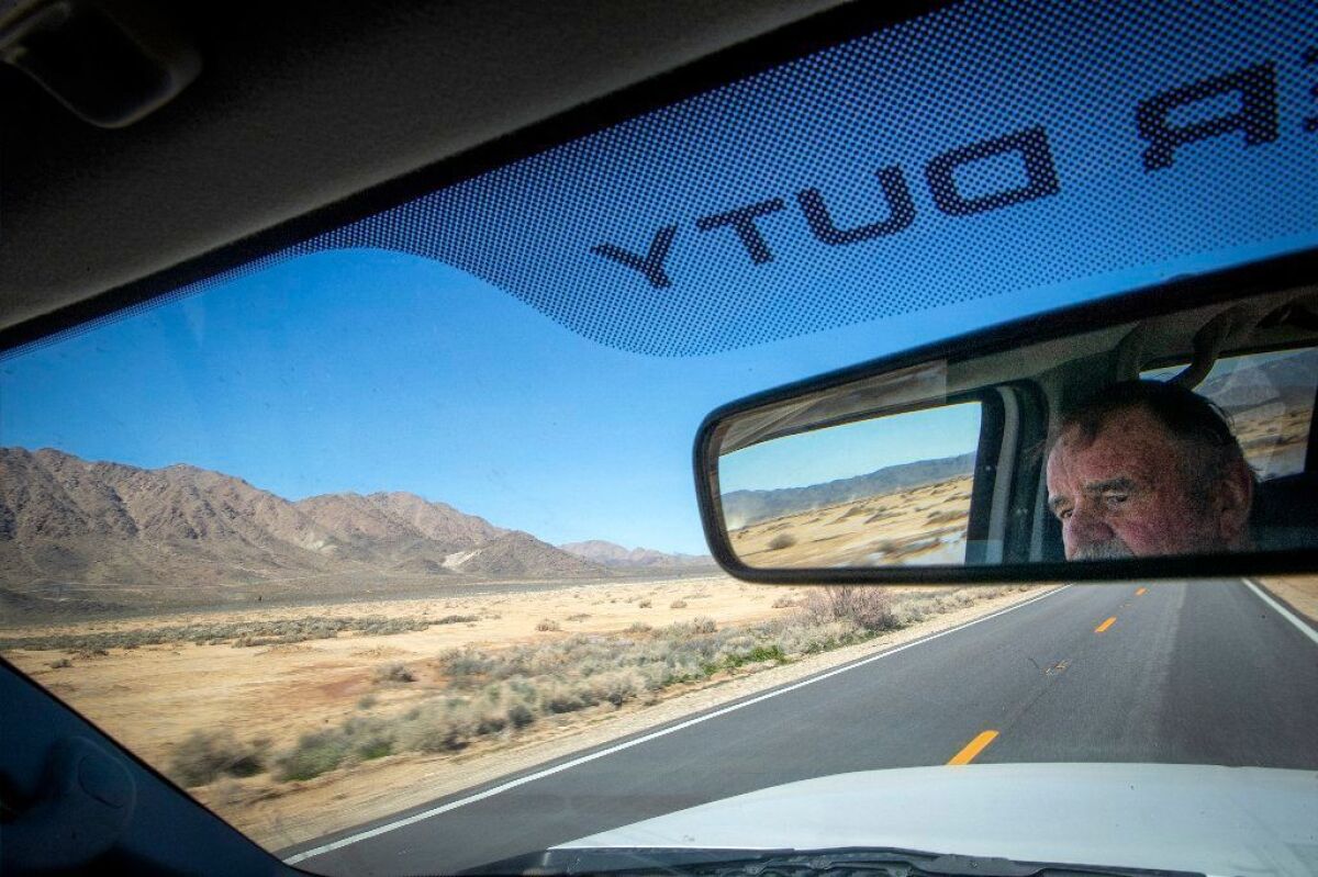 Chuck Bell, a farmer and president of the Lucerne Valley Economic Development Assn., drives along Lucerne Dry Lake, where the Australian construction giant Lendlease hopes to build a 664-acre, 100-megawatt solar farm known as the Calcite project.